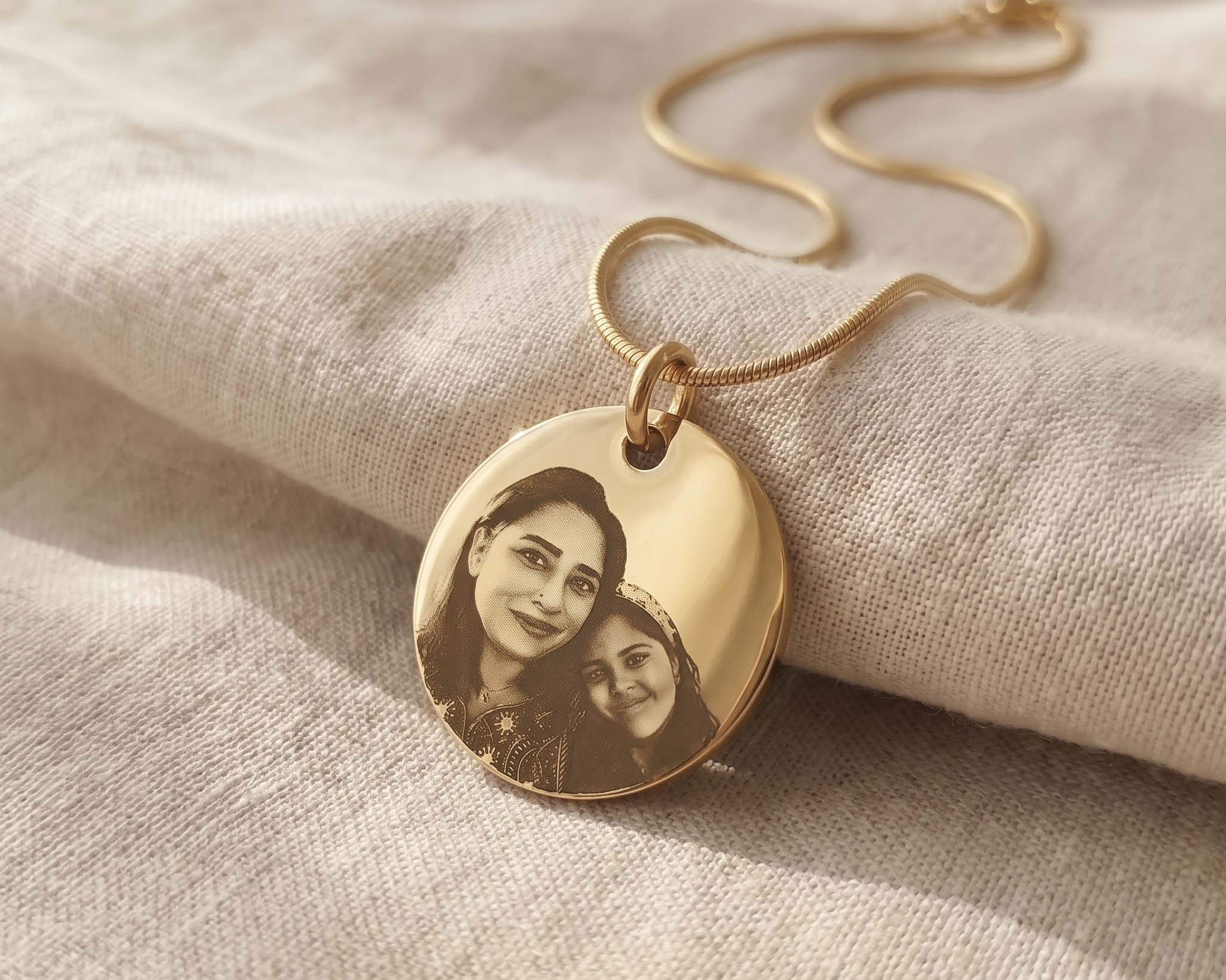 A well-worn memorial pendant resting in an open palm
