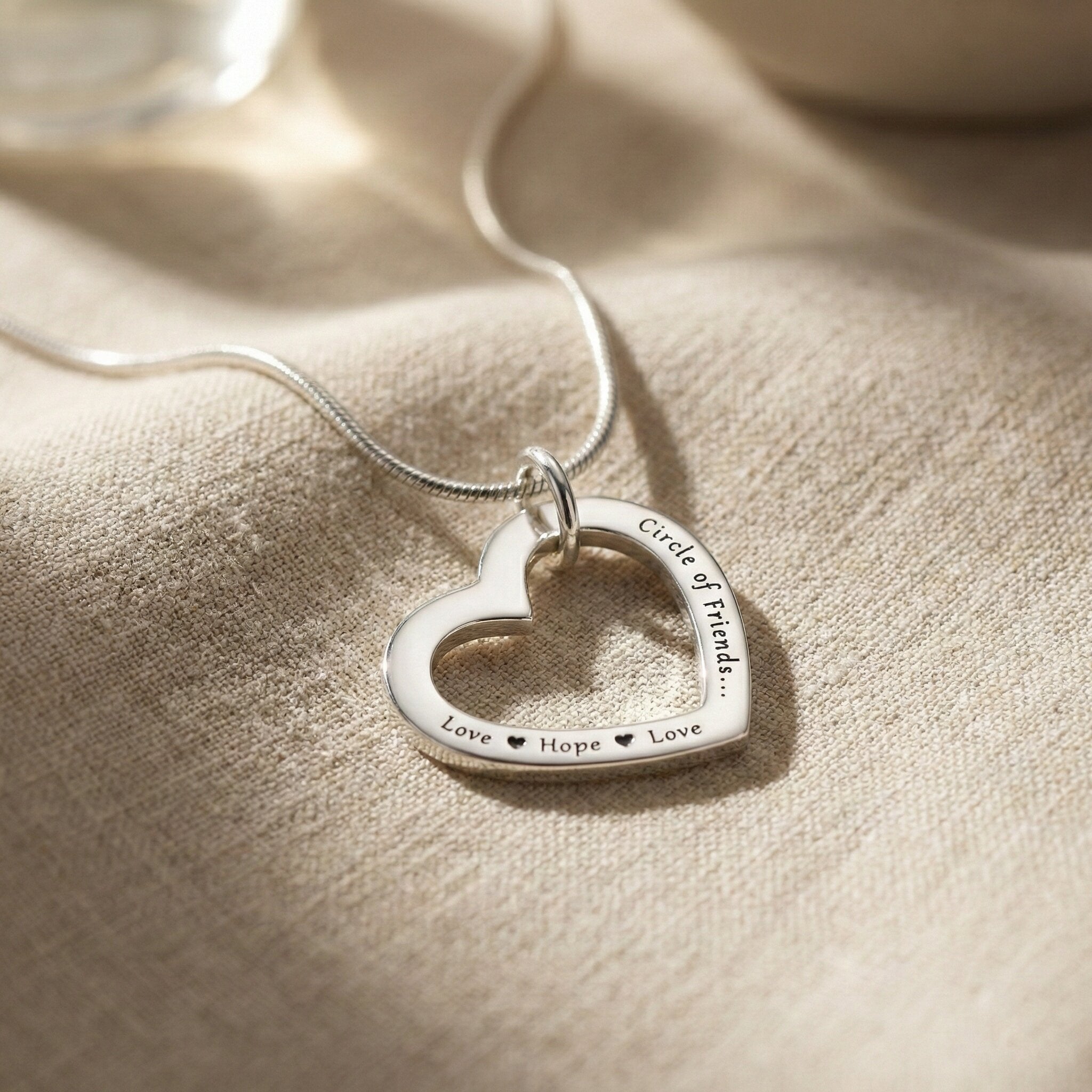 Belle Fever Silver Always In My Heart necklace on soft fabric, personalised heart necklace, romantic engraved jewellery