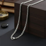 Waterproof curb chain necklace in silver, non-tarnish unisex jewelry laid flat, minimalist everyday chain by Belle Fever.