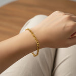 Gold curb chain bracelet styled casually, waterproof unisex jewelry made to last and move with you.