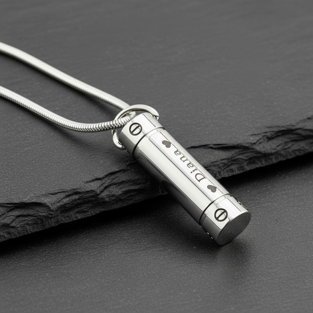 Silver Belle Fever Cylinder Cremation Necklace resting on black leather — a sleek memorial pendant keeping loved ones forever close to your heart.