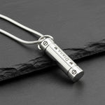 Silver Belle Fever Cylinder Cremation Necklace resting on black leather — a sleek memorial pendant keeping loved ones forever close to your heart.