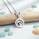 Silver dolphin necklace with custom engraving styled with ocean tones, meaningful belle fever freedom symbol jewelry.