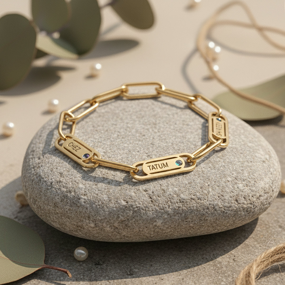 Belle Fever Endless Ties Name Bracelet with Birthstone resting on a stone — a handcrafted symbol of unbreakable love, engraved with names to keep family close forever.