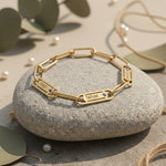 Belle Fever Endless Ties Name Bracelet with Birthstone resting on a stone — a handcrafted symbol of unbreakable love, engraved with names to keep family close forever.