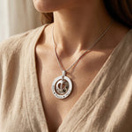 Woman wearing infinity dome necklace, meaningful jewellery symbolising eternal love and family connection