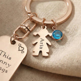 Close-up of kids personalised tag keyring with engraved message, child charm and birthstone detail