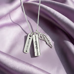 Silver Memory Cremation Necklace by Belle Fever — elegant urn pendant with angel wing and name tag, symbolising eternal love and remembrance.