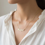 Belle Fever Gold Name Necklace worn close to the heart — a personalised pendant celebrating your name, your story, and your most meaningful connections.