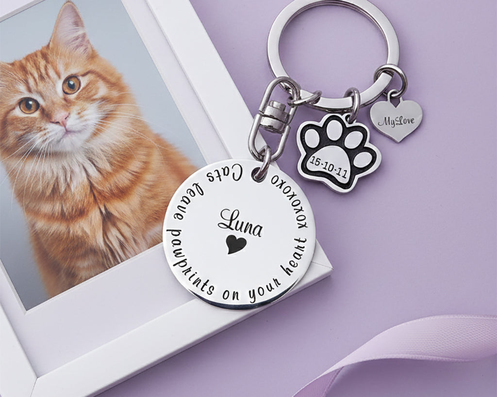 Personalized prints on my heart keyring, pet memorial keychain displayed near pet photo with engraved name disc and paw charm. belle fever meaningful pet tribute keepsake.