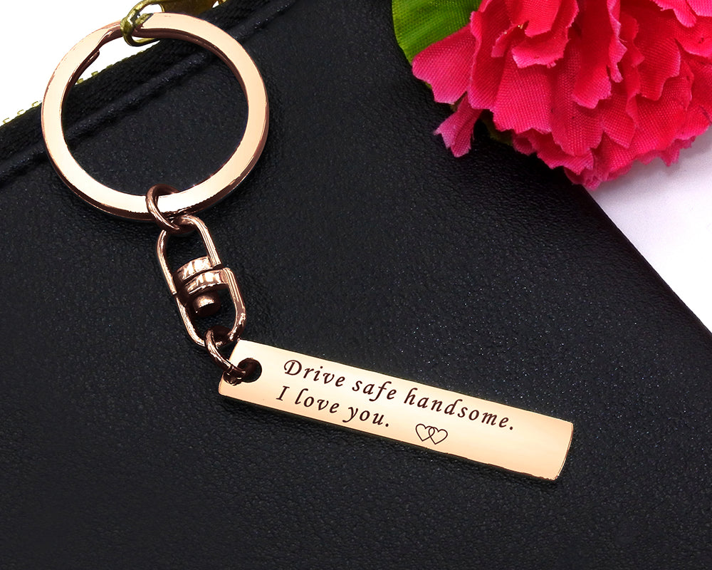 Rose gold reminder tag keychain close-up, engraved bar keepsake with smooth finish, thoughtful gift for loved one, design by Belle Fever 
