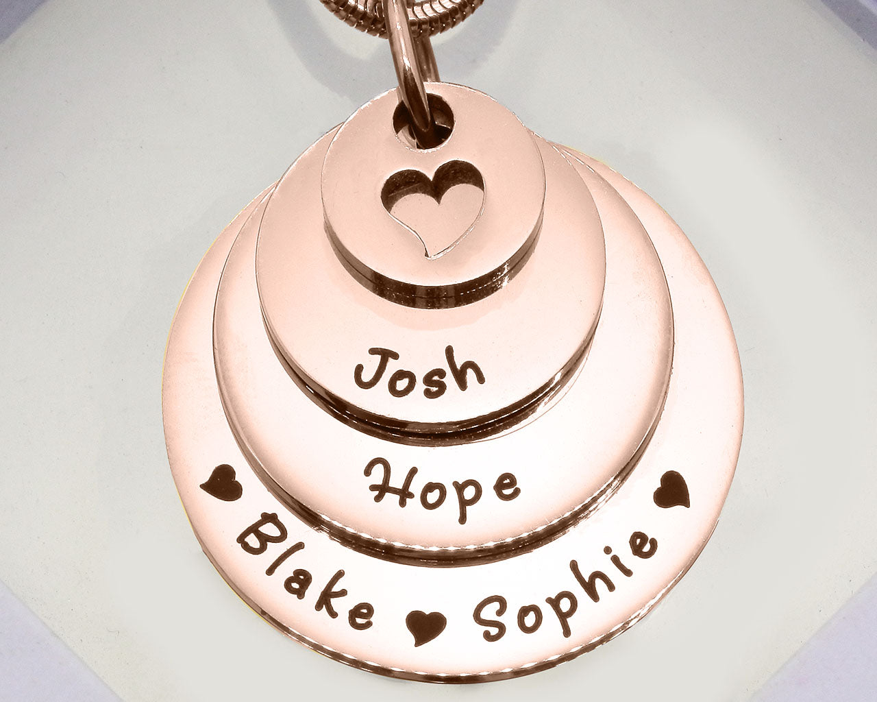 Rose Gold Tower of Love necklace displayed on a white background, layered charm pendant detail by Belle Fever