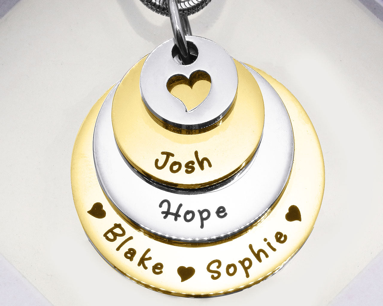 Two Tone Gold Tower of Love necklace displayed on a white background, layered charm pendant detail by Belle Fever