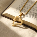 Trust in Him necklace by belle fever styled on book, inspirational Christian necklace with cross heart pendant