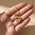 Hand holding Trust in Him necklace by belle fever, faith-based Christian jewelry gift symbolizing trust, hope, and love