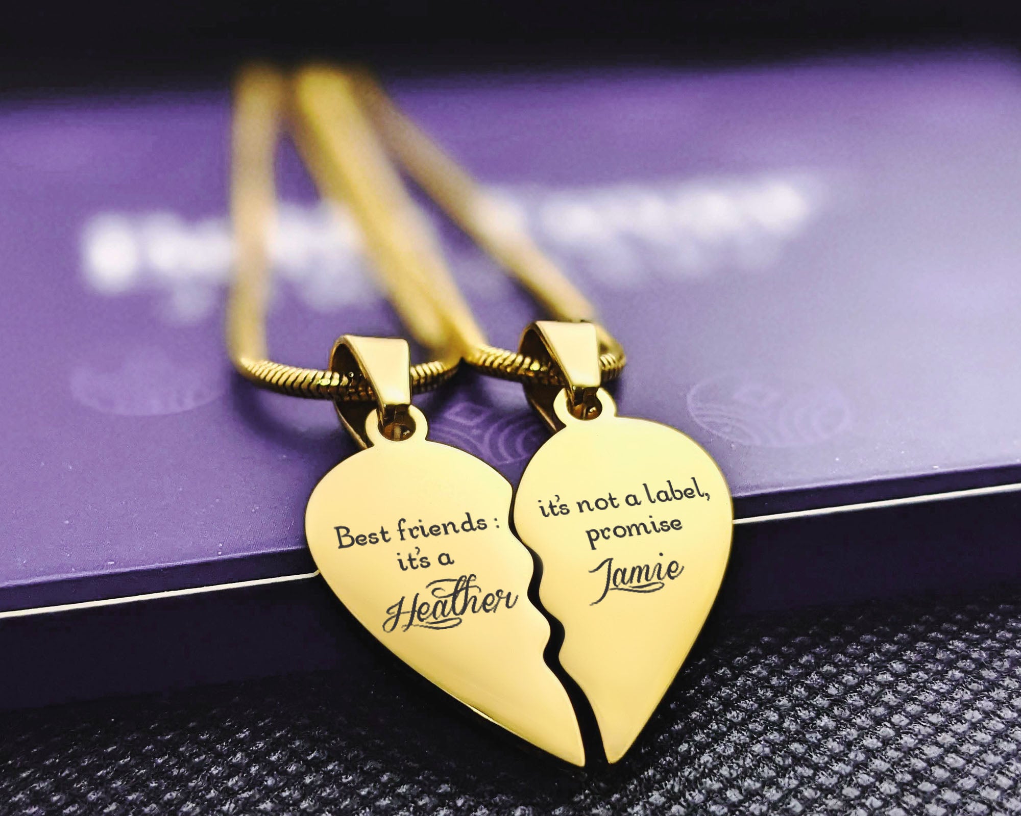 Belle Fever Gold Double Heart Puzzle Necklaces resting on the purple box – a beautiful symbol of two souls connected through love, friendship, and memory.