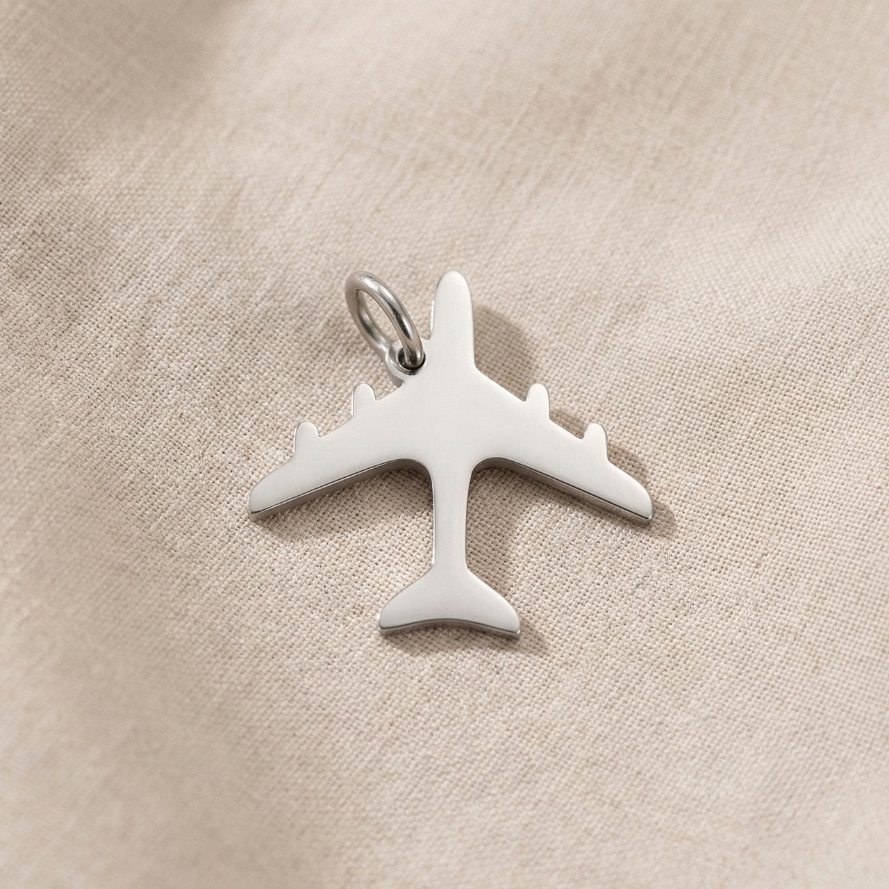 Silver airplane charm for keyring symbolizing travel memories, adventure, and meaningful journey keepsakes