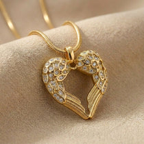Angels Heart necklace with gold heart angel wings pendant on delicate chain displayed on neutral background