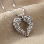 Angels Heart necklace in silver featuring heart shaped angel wings pendant with stone accents