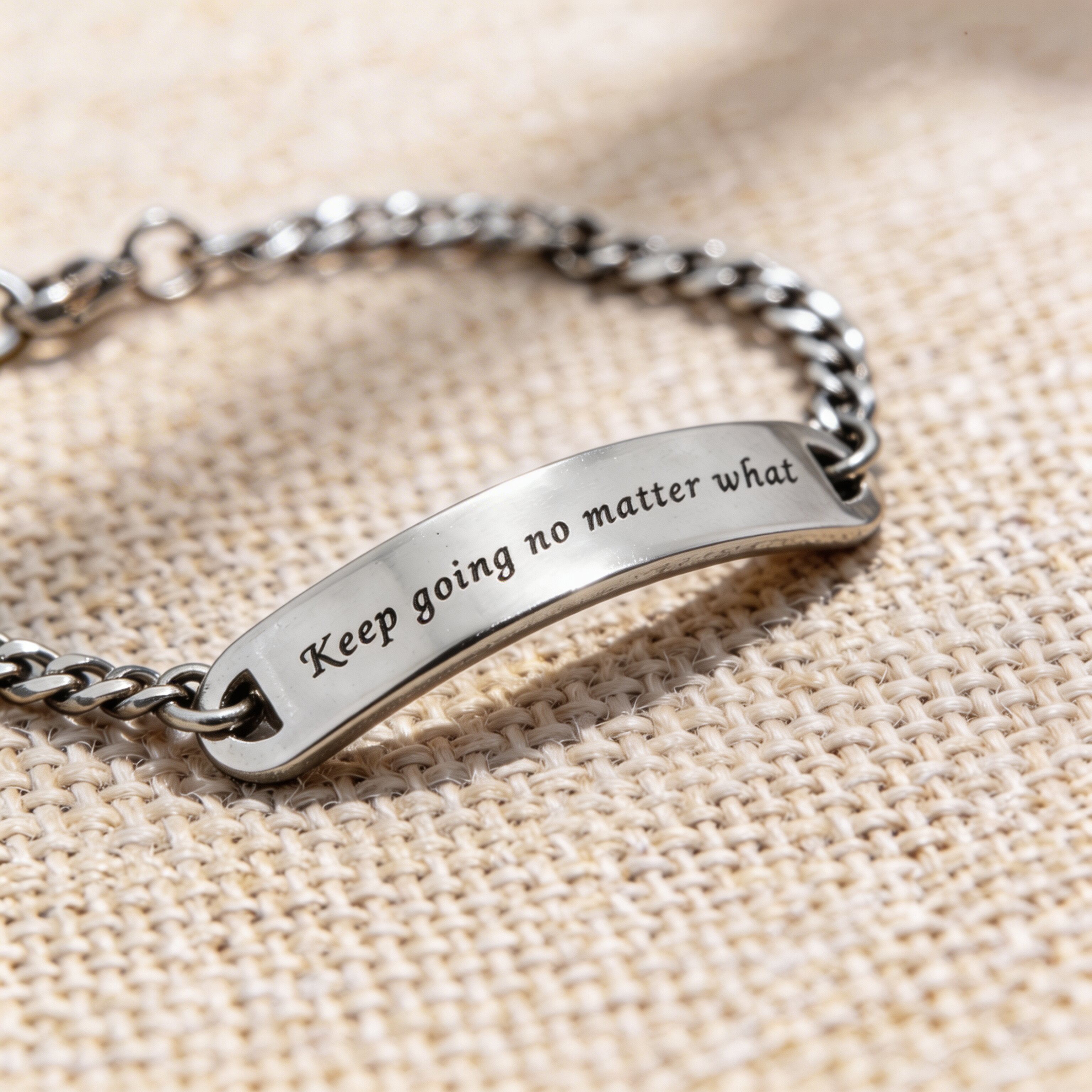 Silver bar bracelet featuring engraved plate detail