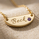 Close up of Beck name necklace with engraved bar pendant and birthstone detail