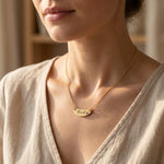 Woman wearing Beck name necklace with engraved bar pendant and birthstone detail