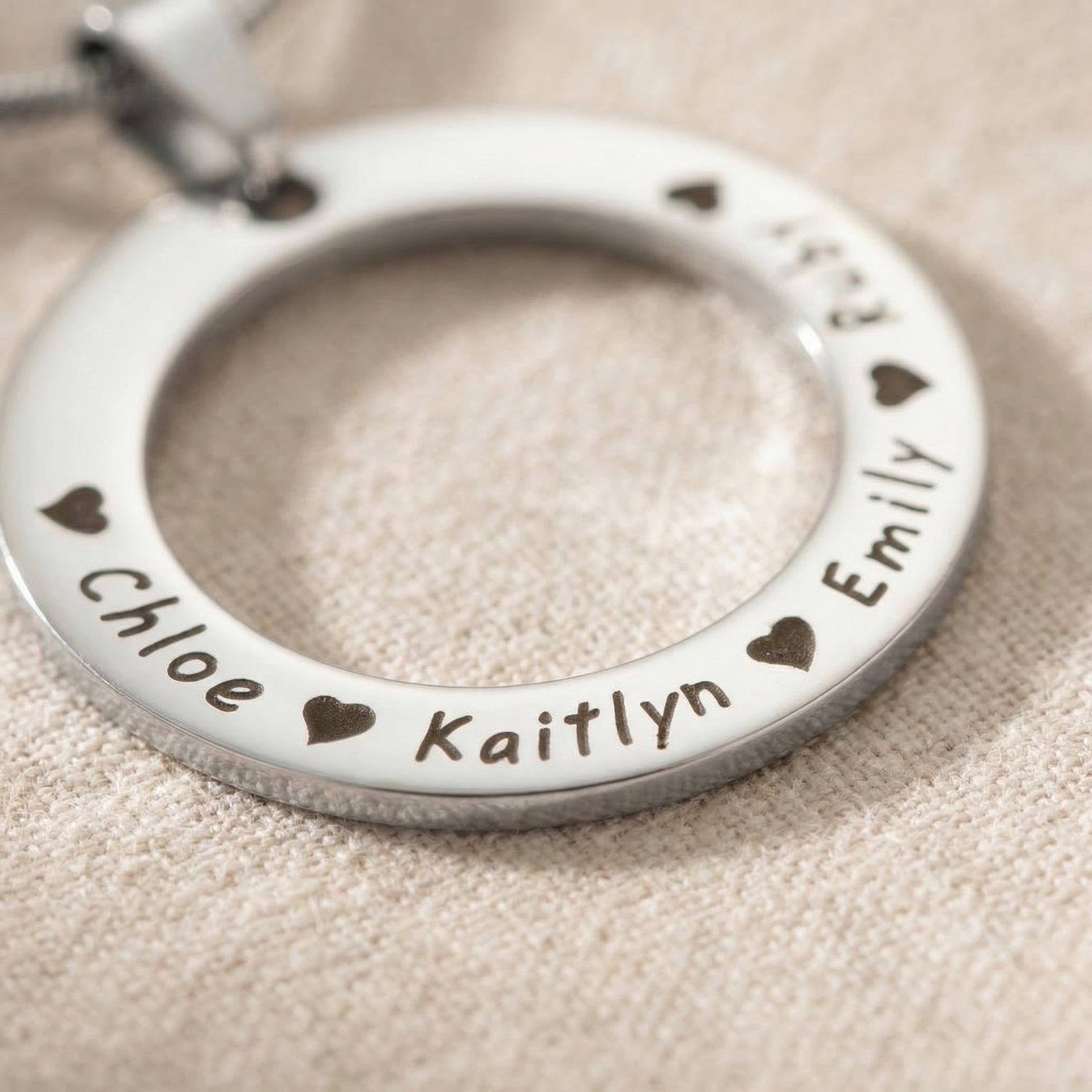Circle of Trust Necklace close-up showing silver personalized circle pendant with engraved names and fine detail