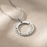 Circle of Trust Necklace silver personalized circle pendant with engraved names minimalist jewelry close-up