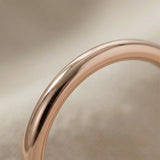 Close-up of classic band ring with smooth polished finish, minimalist gold ring detail