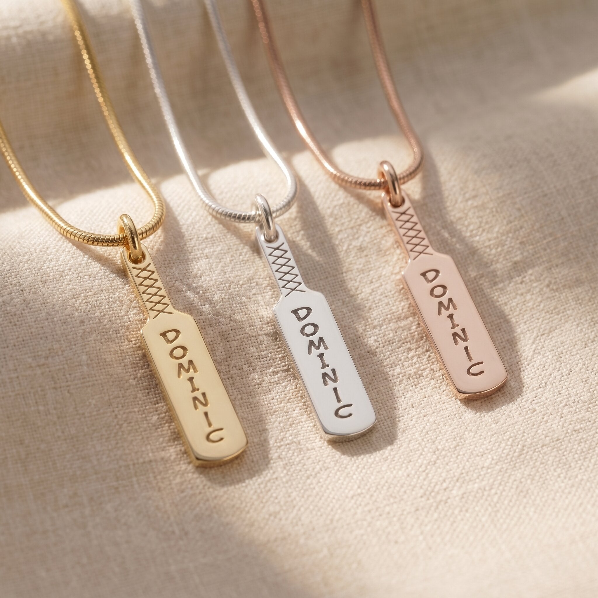Cricket bat name necklace tone comparison showing gold, silver and rose gold finishes