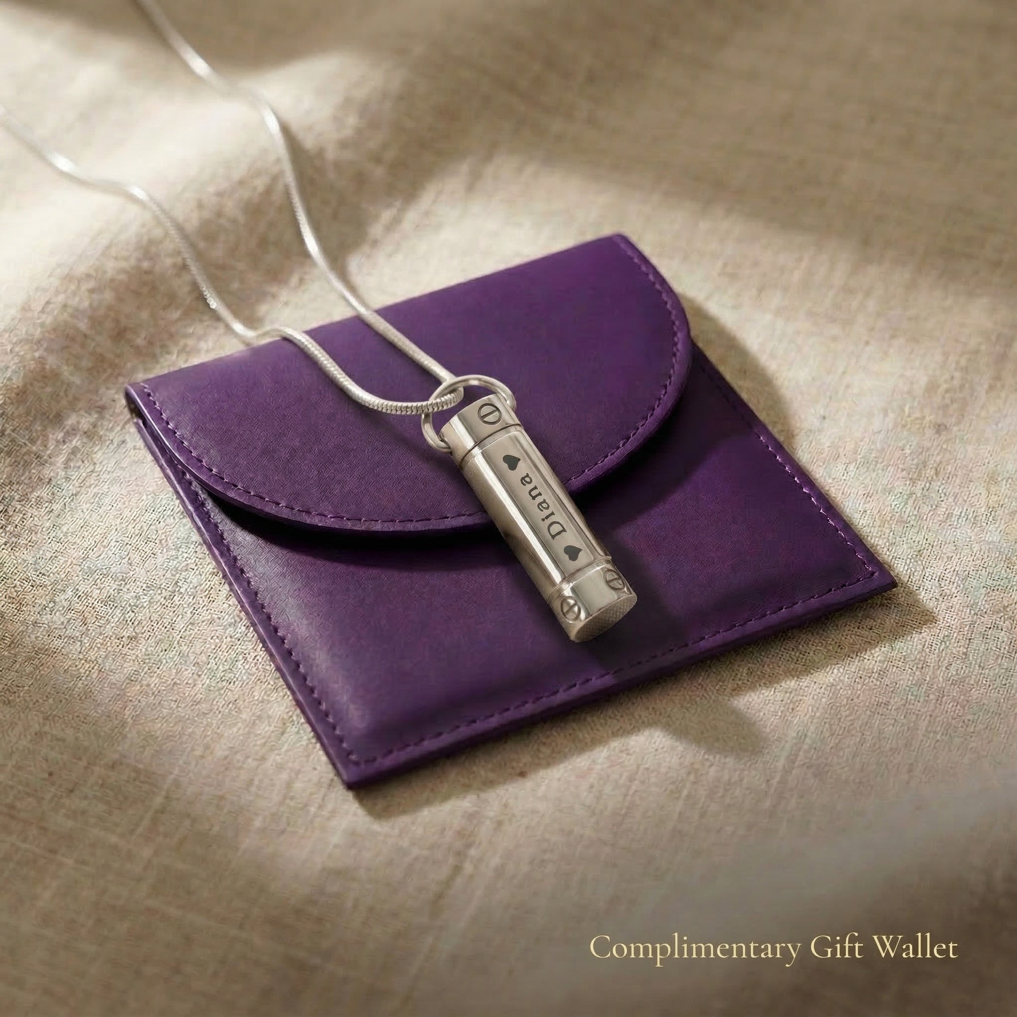 Cylinder cremation necklace displayed with elegant jewelry gift wallet packaging
