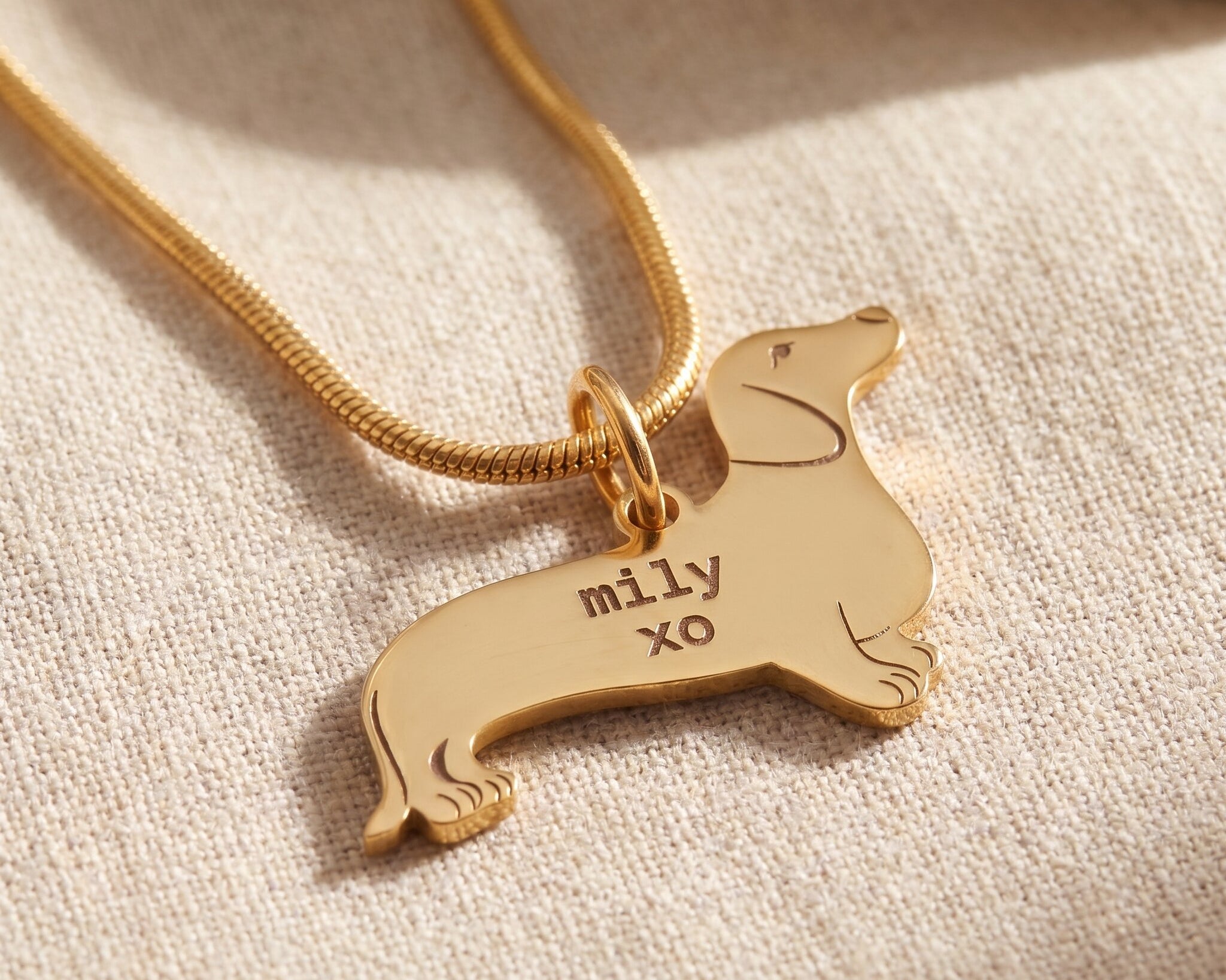 Dachshund dog necklace in gold with engraved detail, personalised dog lover jewellery design