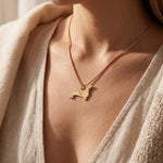 Woman wearing dachshund dog necklace with engraved name, personalised jewellery for dog lovers