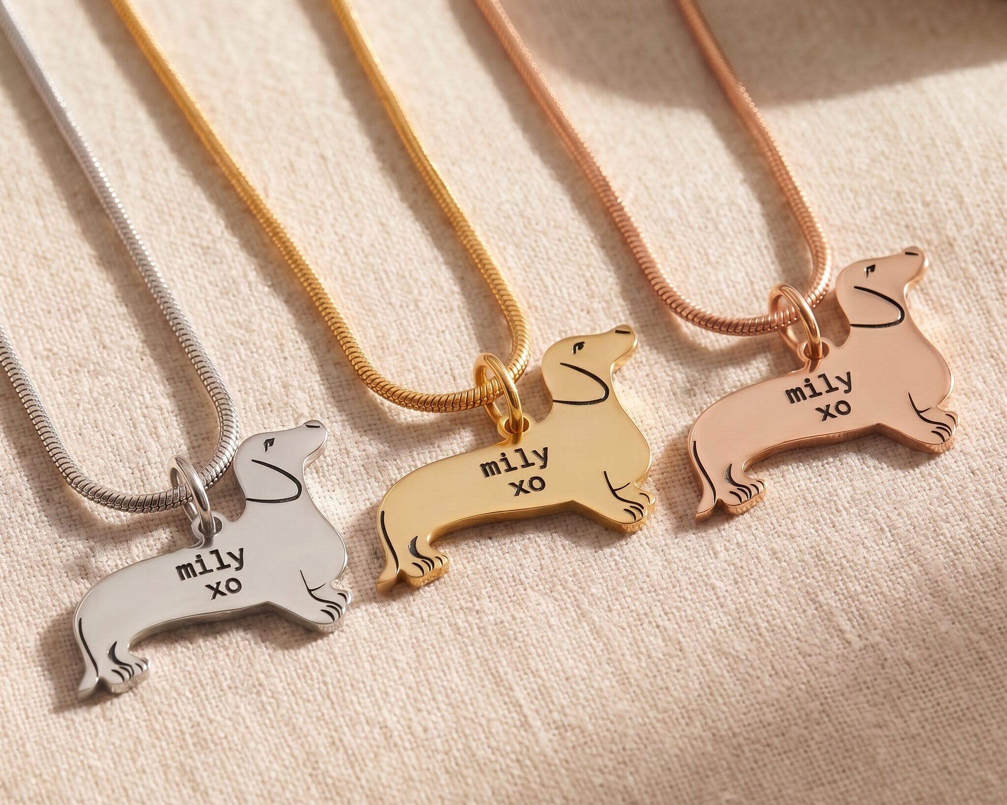 Dachshund dog necklace tone comparison showing gold, silver and rose gold engraved finishes