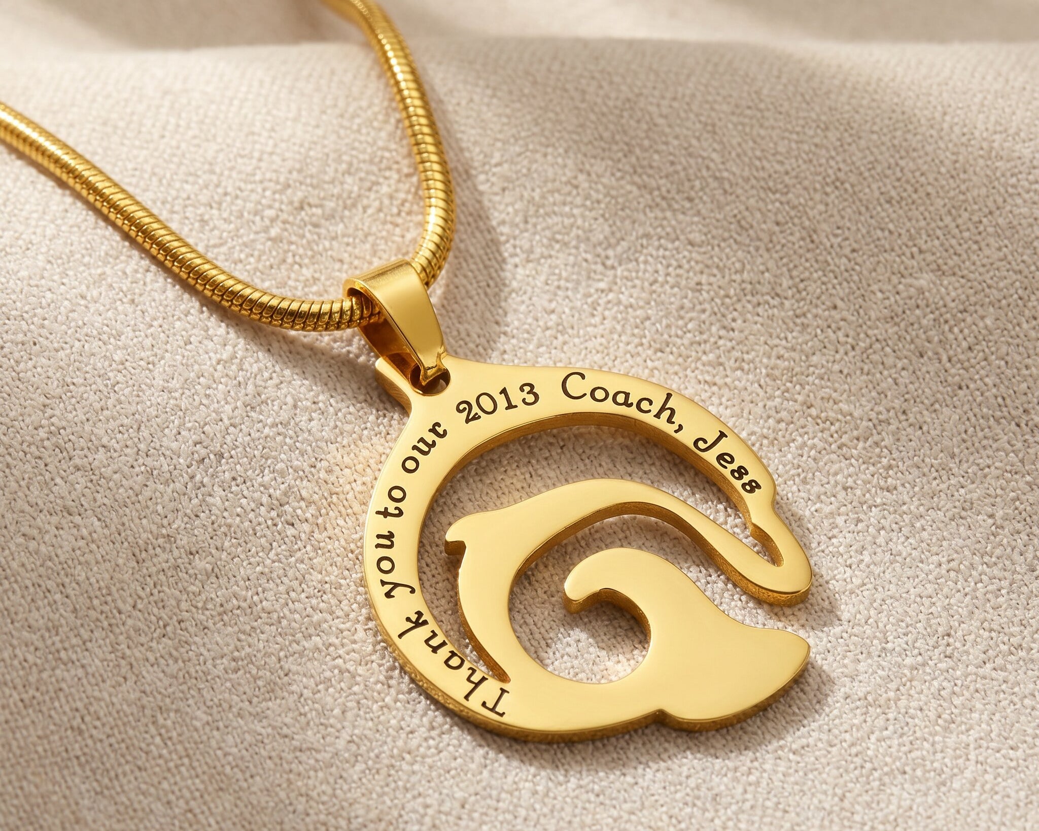Dolphin necklace in gold with engraved name detail, elegant ocean-inspired jewellery design