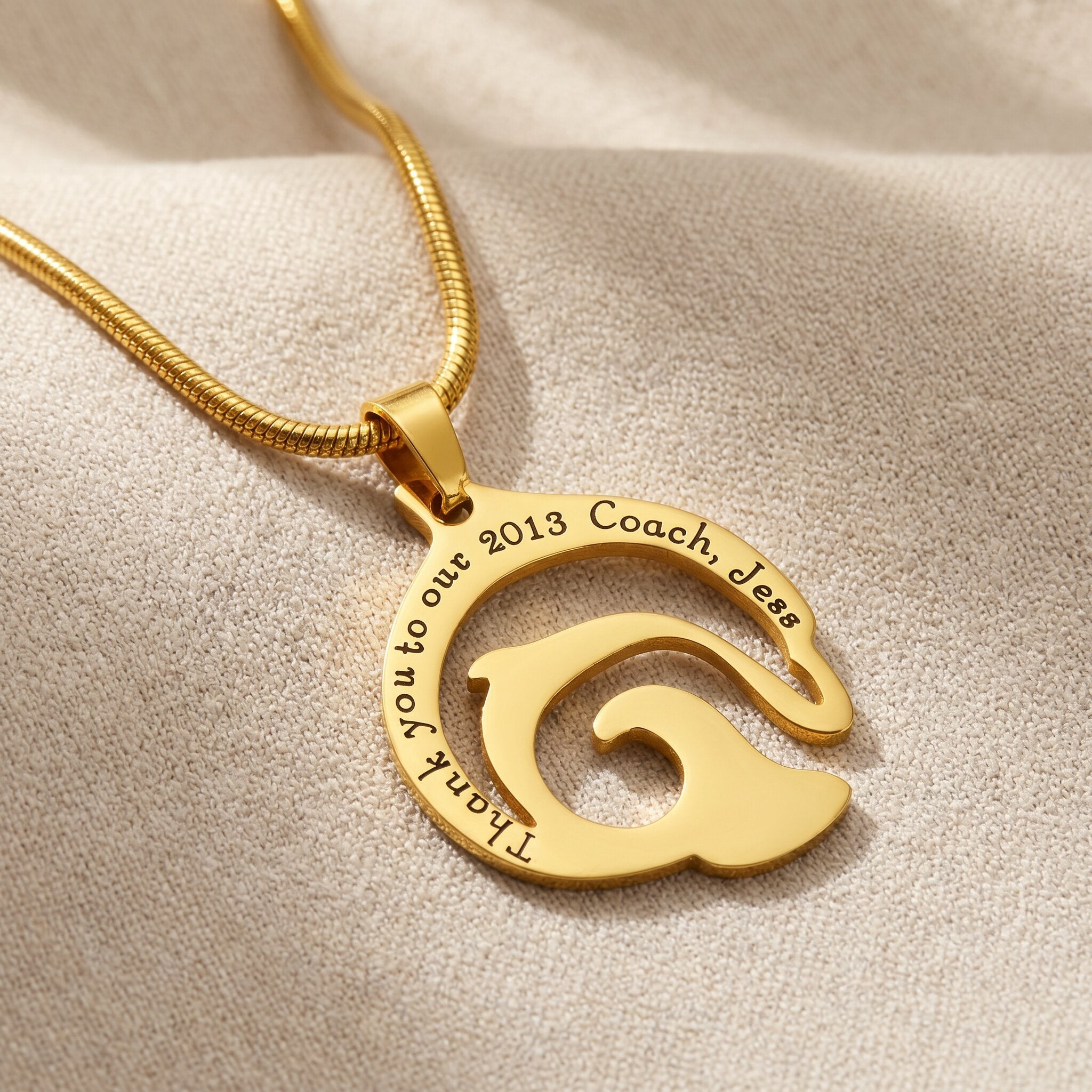Dolphin necklace in gold with engraved name detail, elegant ocean-inspired jewellery design