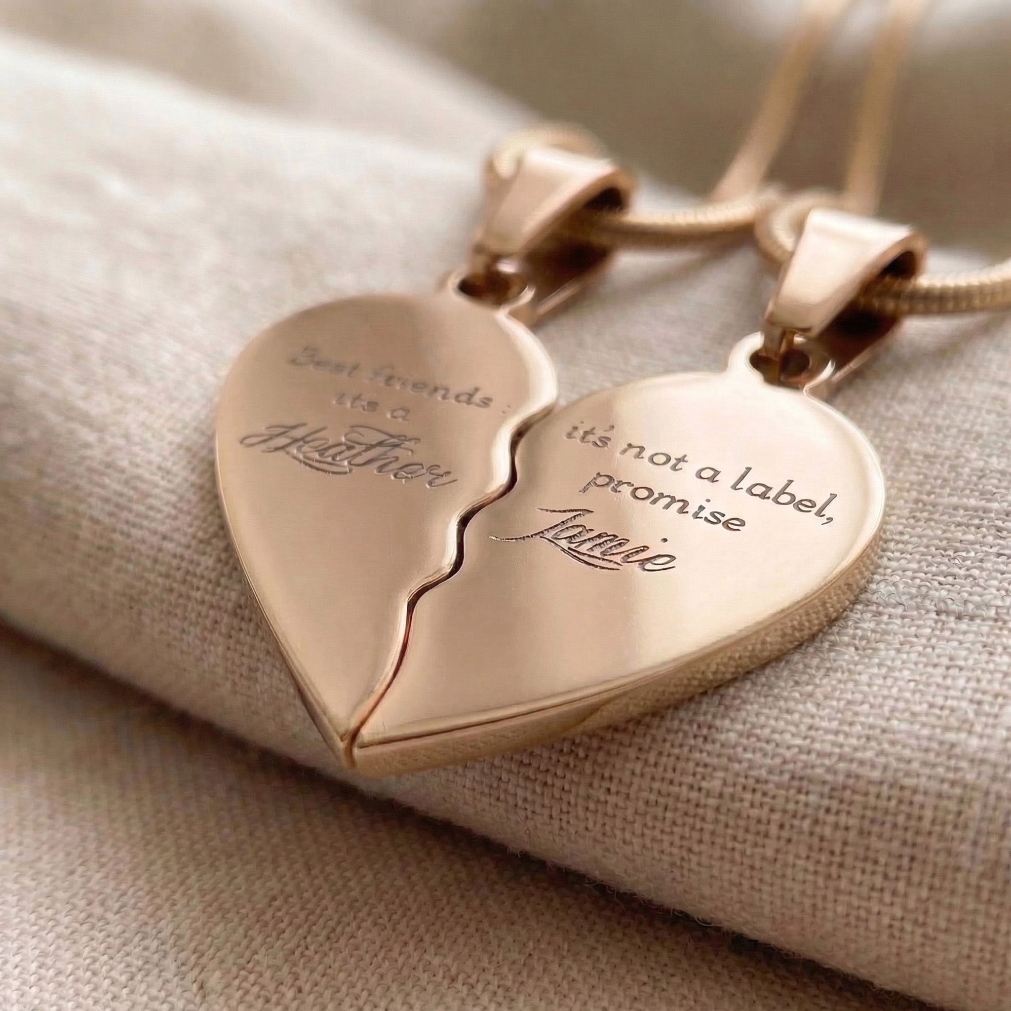 Close-up of Double Heart Puzzle Necklace set showing engraved message on interlocking heart pendants