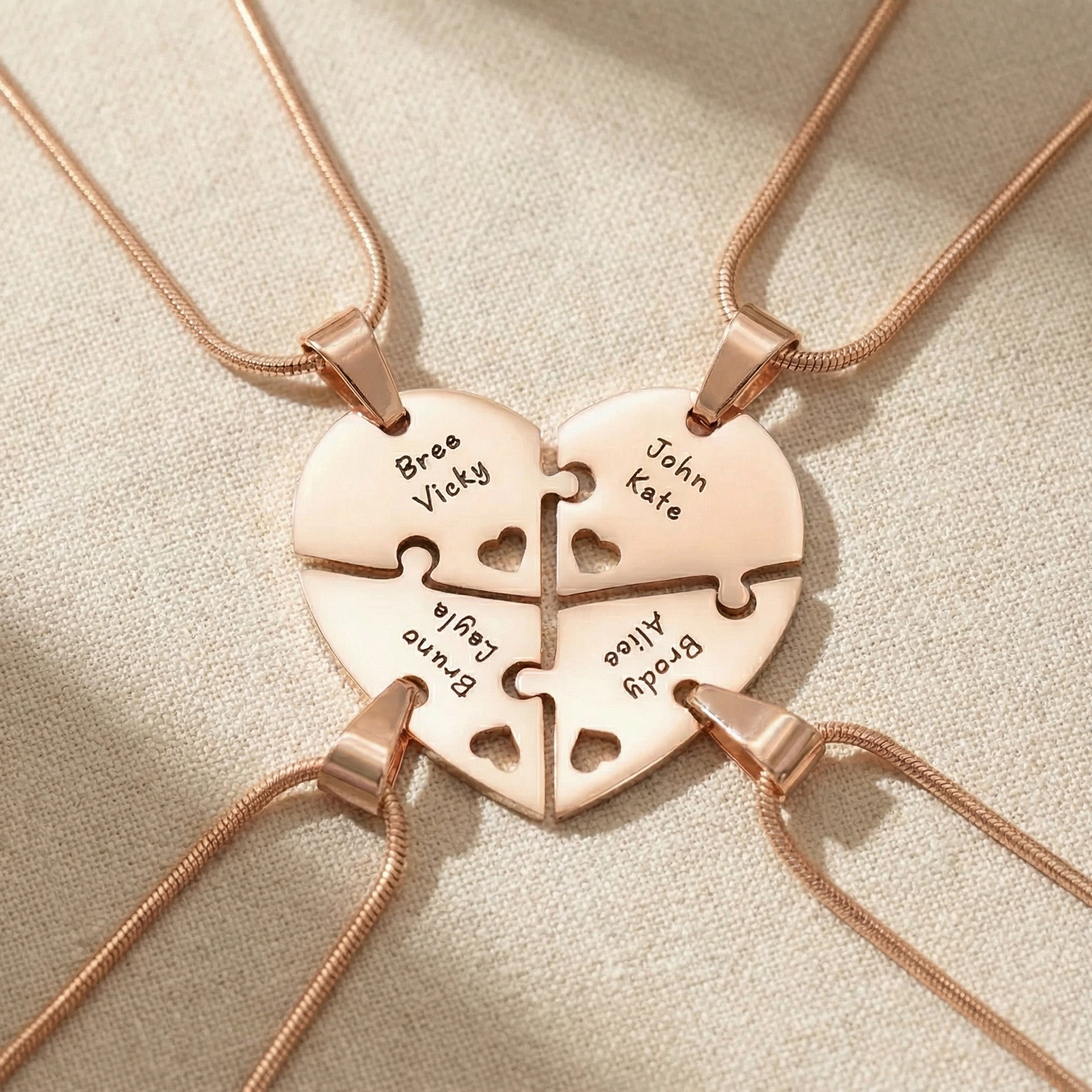 Heart Puzzle Necklace in rose gold with four interlocking engraved pieces forming heart design