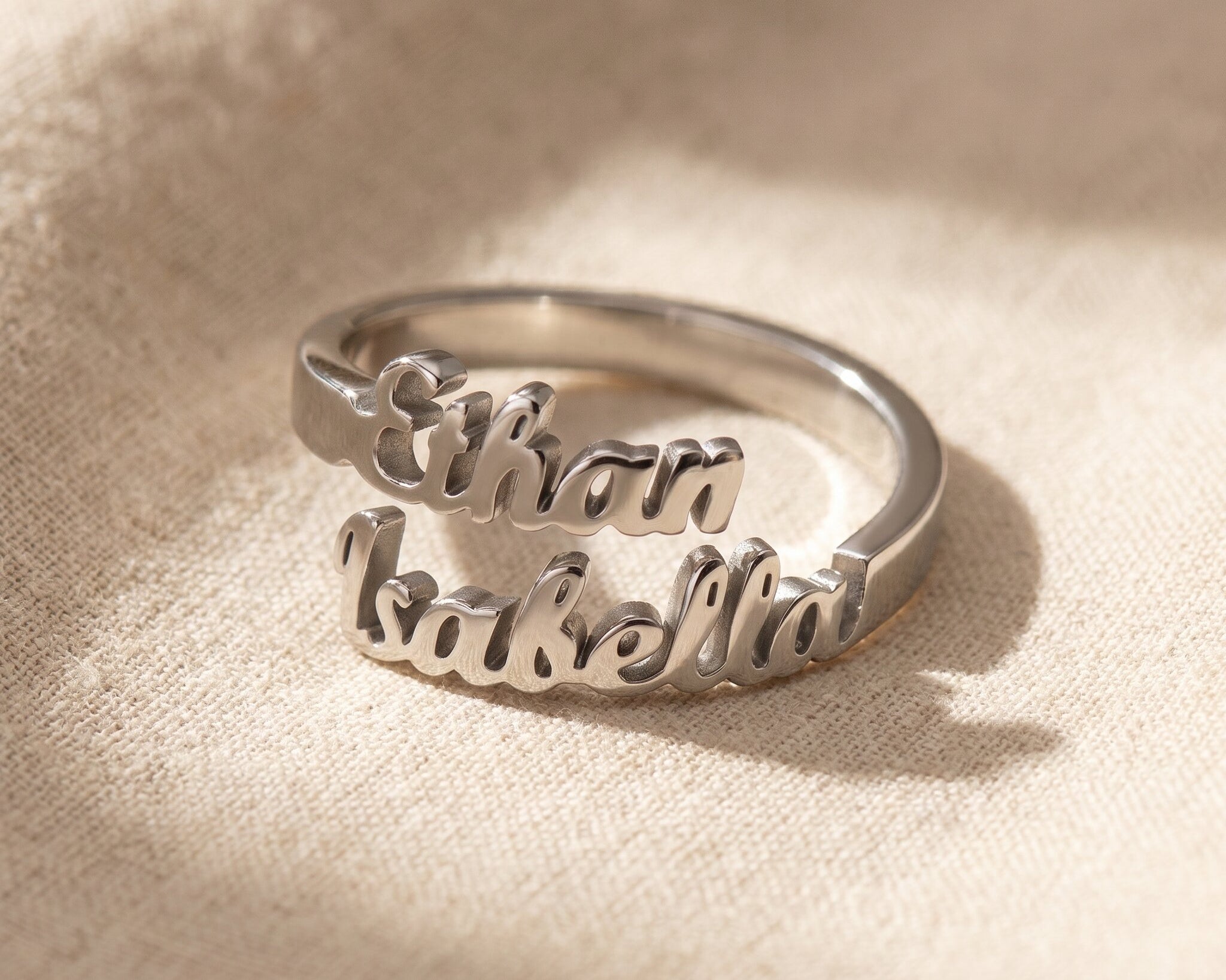 Personalized double name silver ring with custom script design and polished minimalist jewelry finish