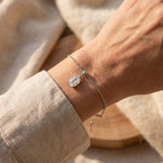 Woman wearing empowerment bracelet with crystal pendant, delicate everyday jewellery for women