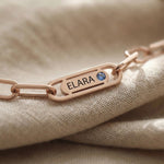 Close-up of Endless Ties Necklace showing engraved name on link with fine detail and polished finish