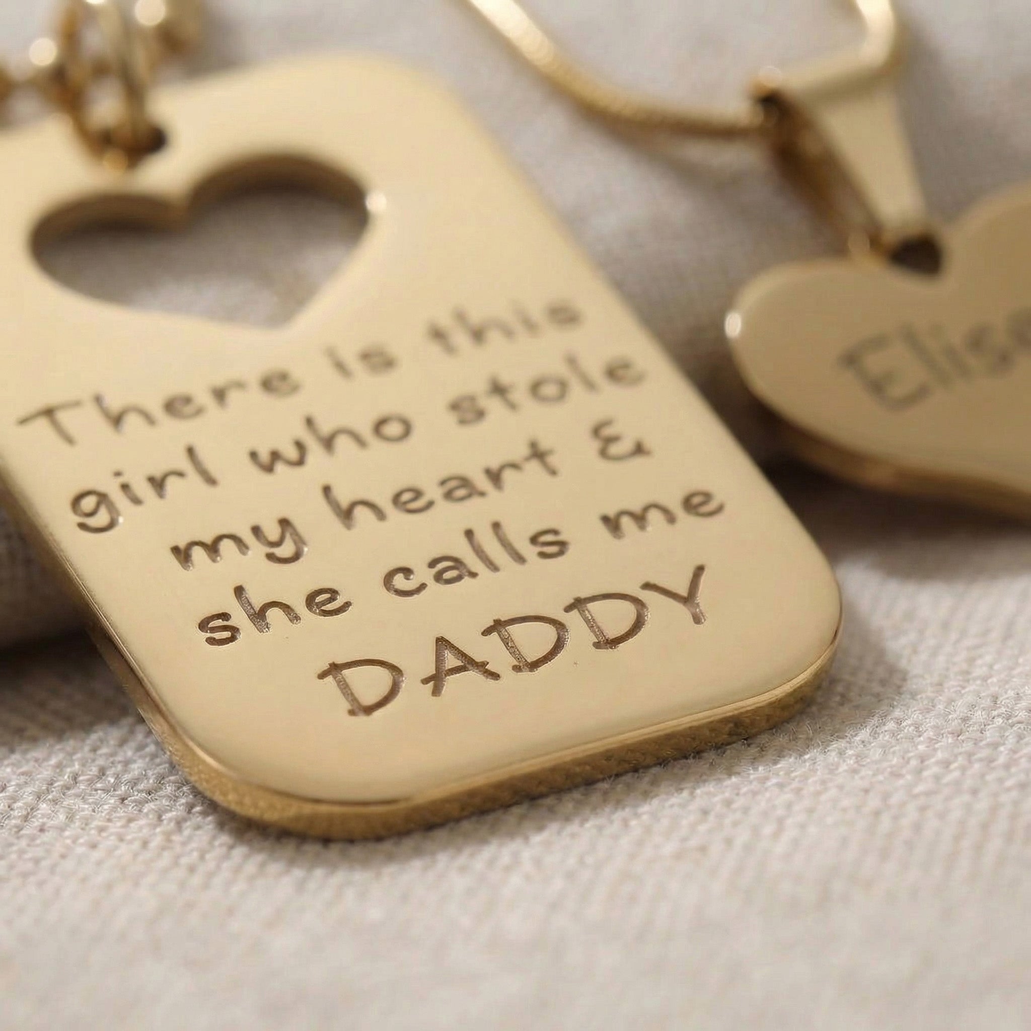 Close-up of Father & Daughter Necklace Set showing engraved message and heart cut-out pendant detail
