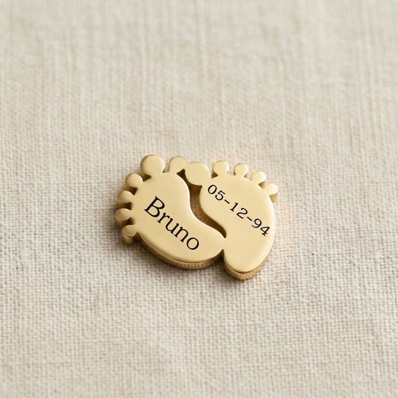 Gold baby feet charm for Dream Locket bracelet symbolizing motherhood, newborn memories, and family love