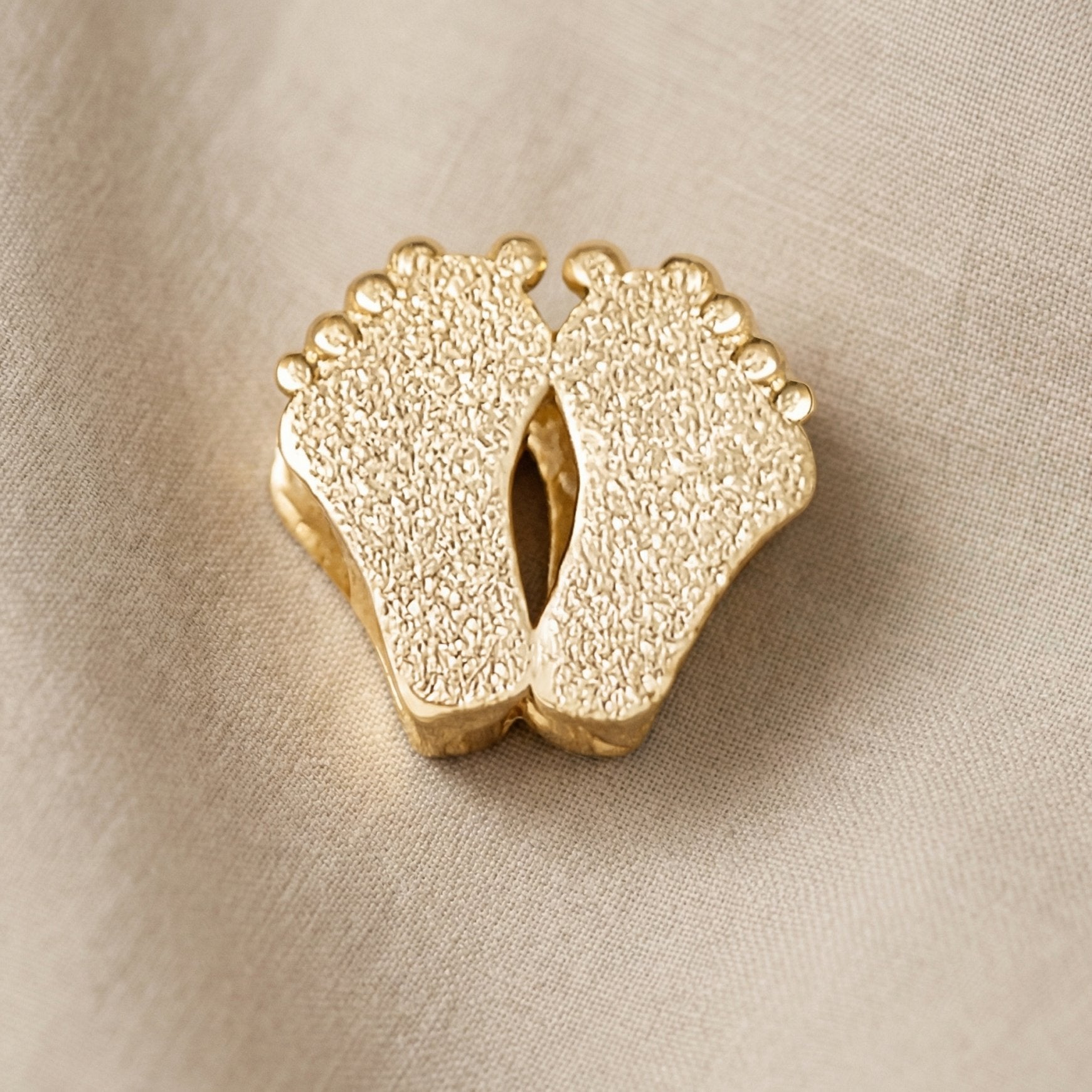 Gold baby feet charm for Moments Bracelet symbolizing motherhood, newborn memories, and family love