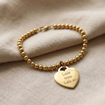 Forever In My Heart Charm Bracelet in gold with engraved heart charm, personalised jewellery hero image