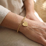 Woman wearing Forever In My Heart Charm Bracelet with engraved heart charm, personalised jewellery lifestyle image