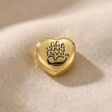 Gold heart charm with hand illustration for Moments Bracelet symbolizing love, loyalty, and connection