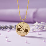 Hand on My Heart Necklace by Belle Fever —  engraved handprint pendant styled with lavender tones, a heartfelt memorial necklace keeping loved ones close