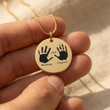 Hand on My Heart Necklace by Belle Fever — gold engraved handprint pendant held gently in hand, a sentimental keepsake jewellery piece full of love and meaning.