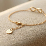 Close up of infinity bracelet with delicate chain and infinity symbol detail